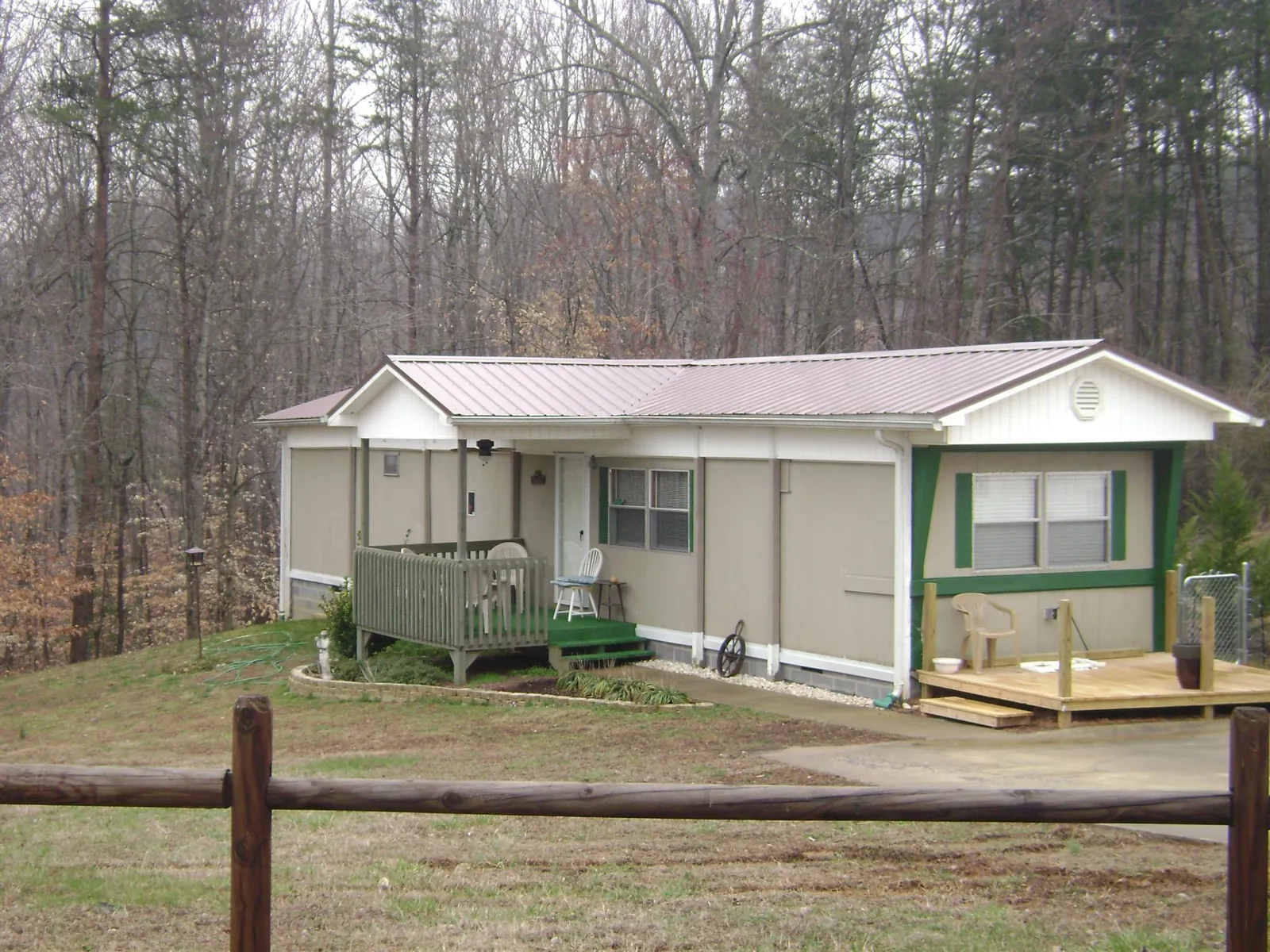 Mauve metal roof on a manufactured home with a new front deck in Rapids City